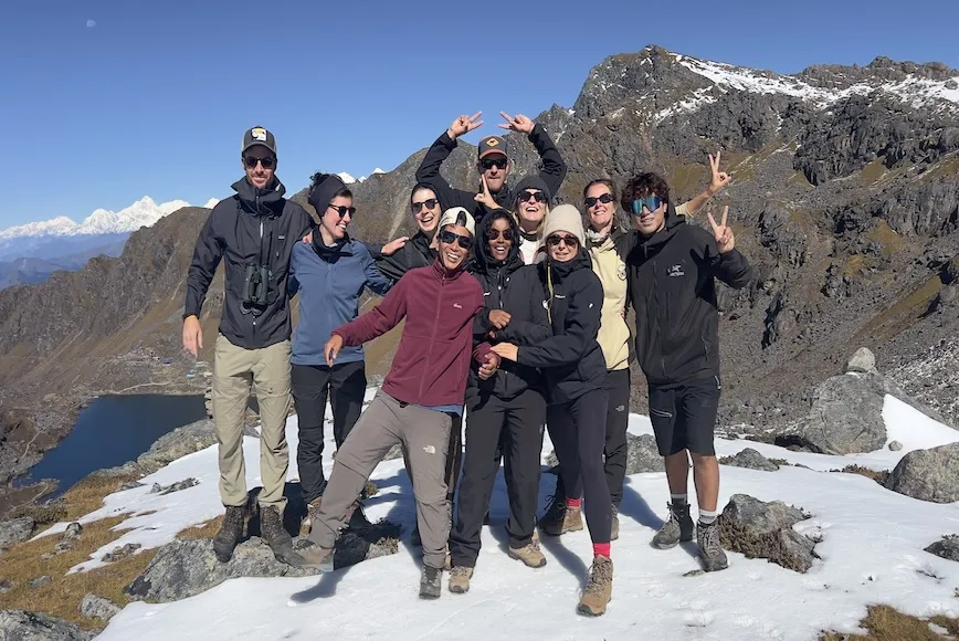 Trekkers enjoying the scenic surroundings of Gosaikunda Lake during the Langtang Gosaikunda Helambu Trek in Nepal.